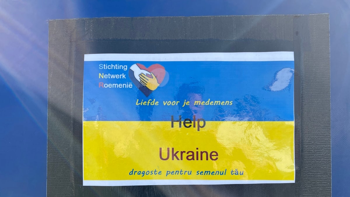 a sticker on the side of a blue car